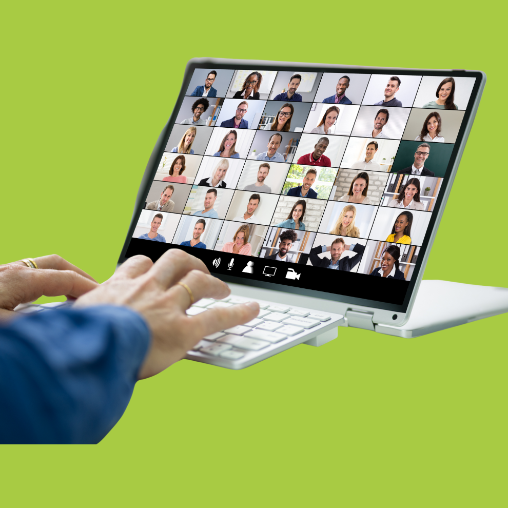 A white laptop displaying a webinar with many guests. A persons hands are on a keyboard typing
