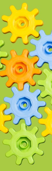 Green blue and yellow cogs are interconnected against a green background