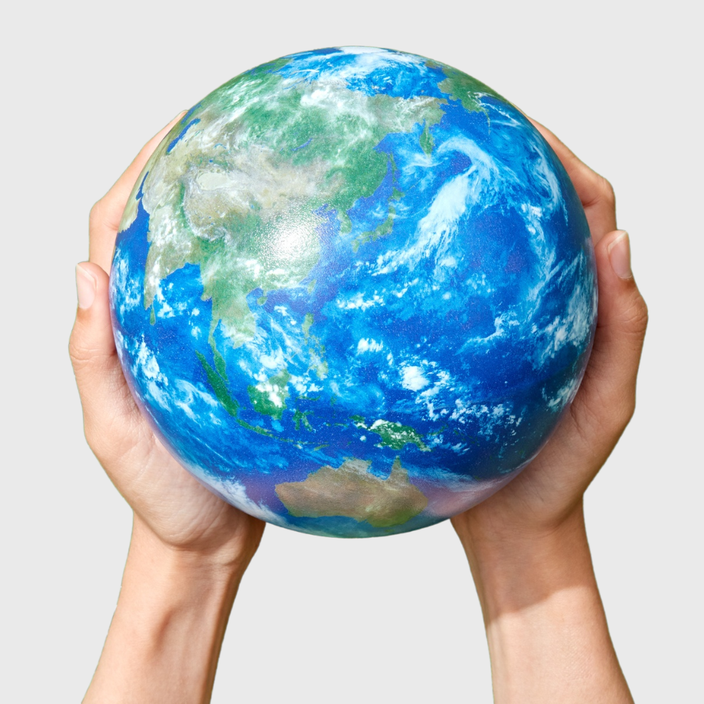 Two hands holding up a circular globe of the Earth