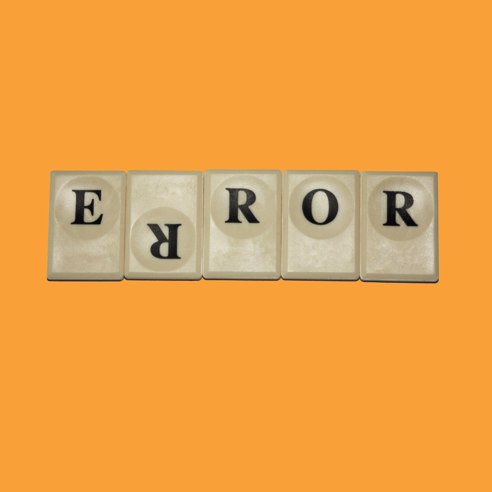 Individual game tiles with one letter each spelling the word 'Error'. One R is upside down. Image has an orange background.