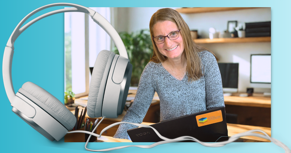 A woman with long blonde hair and glasses smiles warmly at the camera, she sits in front of a laptop in a sleek modern office environment. A large graphic of some headphones overlaps the image.