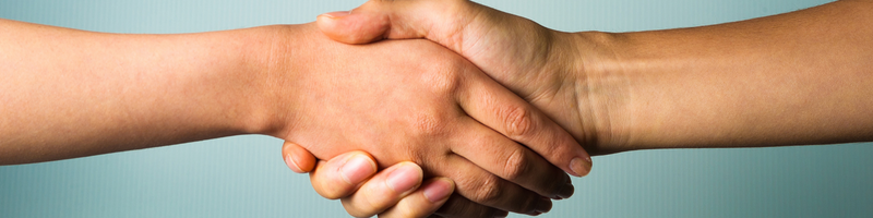 A close up of two hands shaking